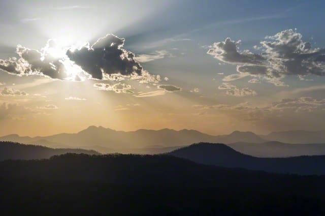 Sunrays over mountain ranges .